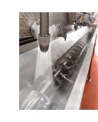 This stainless steel Large Super Air Nozzle removes debris from a stainless steel screw conveyor.