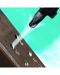 This PEEK Pico Super Air Nozzle is blowing dust and debris from this metal punching operation.